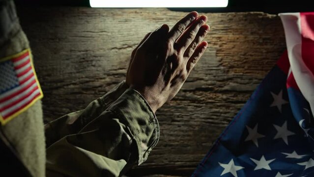 Soldier praying with hands folded on veterans day 