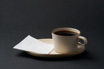 Black coffee and coffee beans on black background