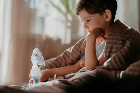 Elementary boy looking at nebulizer