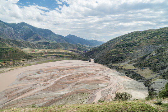 View of the Pyandzh River (Ochus River) across the valley with mountains next to the Pamir highway in Tajikistan.