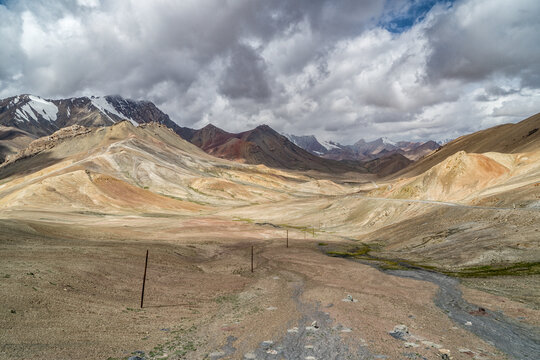 View of the Ak Baital peak and road on Pamir highway in Tajikistan.