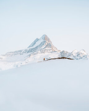 View of hiker with the Mittelhorn mountain in background in Grindelwald, Switzerland.