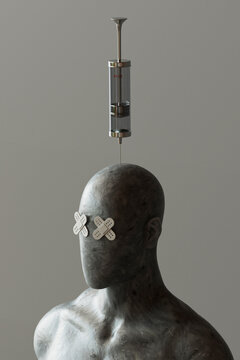 Mannequin with band aid eyes and syringe pierced in head against gray background
