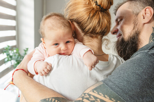 Parents with newborn daughter at home