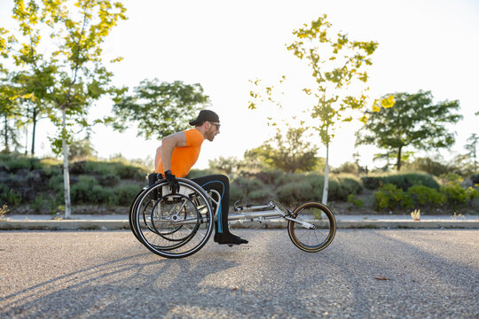 Dedicated athlete taking part in wheelchair race competition