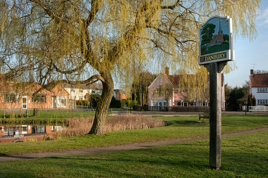 DANBURY, ESSEX, UK - APRIL, 10, 2010:  View Village sign with  village green and duck pond in the background