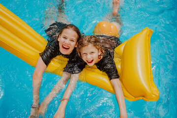 Cheerful girls having fun in swimming pool