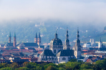 Germany, Bavaria, Wurzburg,Fog gathering over St John in Stift Haug