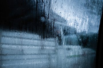Raindrops on the window glass, abstract background.