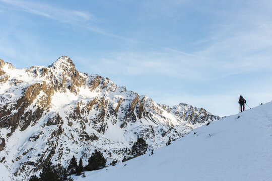 Man hiking with pole on snow covered mountain