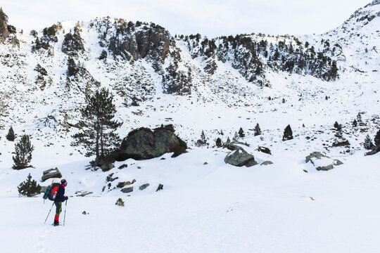 Man hiking with pole on snowcapped mountain