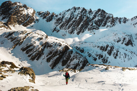 Man hiking on snow covered mountain in winter