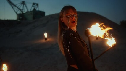 Beautiful Young Woman Dancing And Rotating Burning Torches Outdoors In Night