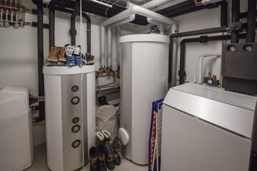 the interior of a modern boiler room - technical room with equipment of an family house with...