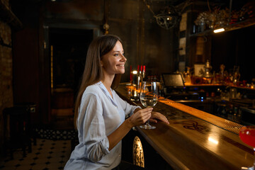 Happy smiling woman celebrating personal achievement resting at bar counter