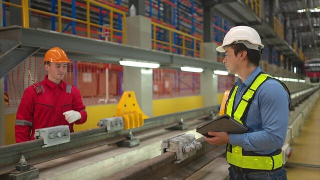 After the electric train is parked in the electric train repair shop, Electric train engineer and technician with tools inspect the railway and electric trains in accordance with the inspection round