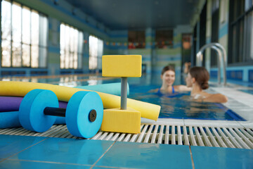 Aqua aerobics class gymnastics training lesson at health club with swimming pool - obrazy, fototapety, plakaty