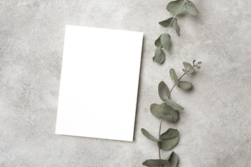 Stylish wedding invitation card mockup with eucalyptus twigs decor, blank card with copy space