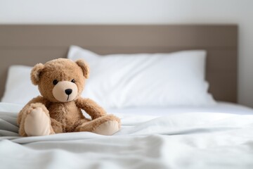a teddy bear on an empty bed for a foster child