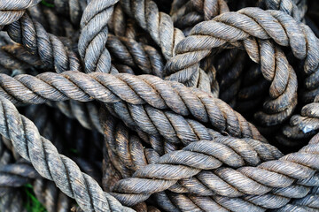 Antique rope made from natural materials. Fragment of a braided cord of large diameter. Close-up