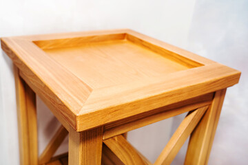 Fragment of a bedside table made of natural wood. Joinery in retro style. Close-up. selective focus