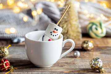 Hot chocolate mug and a snowman made of marshmallows.