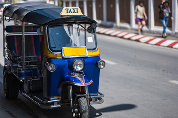 Fototapeta na wymiar Tuk Tuk, Thai traditional taxi car, parking for tourist passenger in Thailand. No identifiable logo or element