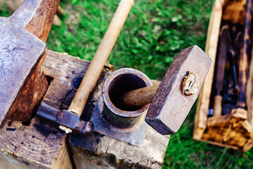Blacksmith's hammer and anvil. Ancient tools for forging metal. Retro style. selective focus