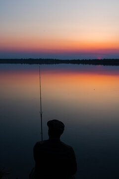 Fishing rod at sunset close-up. Vertical photo. High quality photo