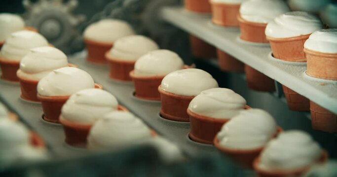 Ice cream sundae in a waffle cup. Cold storage conveyor for ice cream production. Ice cream production.Ice Cream Production Line. Filling of Wafer Cups with Ice Cream. Ice Cream Factory
