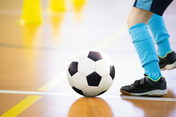 Futsal player kicking soccer ball. Soccer training dribbling drill. Indoor futsal soccer players...