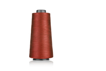 spool of industrial threads of brown color, texture of threads on a white background