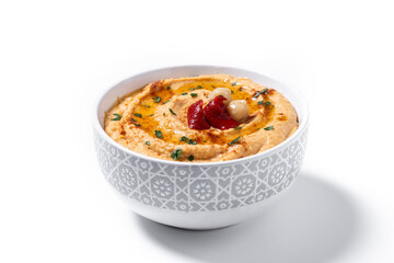 Roasted red pepper hummus in white bowl isolated on white background