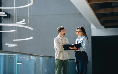 Business partners having a discussion as they review a document in an office