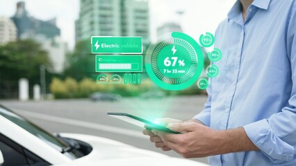 Modern businessman check battery status from smartphone mobile 3D hologram while his EV car...