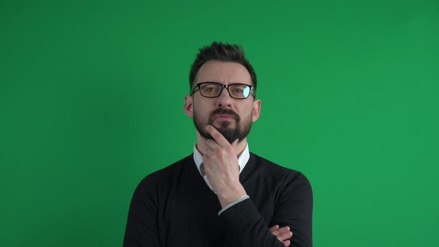 Thoughtful man in glasses thinking or considering. Businessman making choice. Pensive european man wearing spectacles isolated on green screen studio background. Question decision or doubt concept