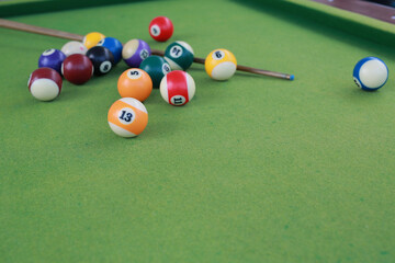 Billiard balls on a green billiard table.