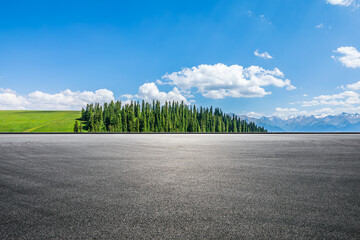 Asphalt road and green forest with mountain natural landscape under blue sky