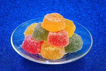 Fruit marmalade with sugar coating. Colorful jelly candy on glass plate. Yummy dessert confectionery. - 666487631