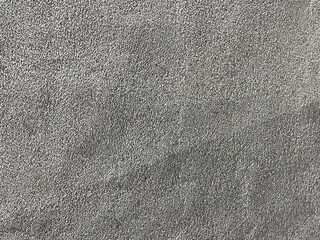 the texture of concrete or uneven rough putty or plaster
