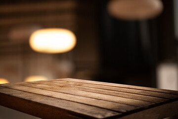 empty table to showcase your product on blurred golden bokeh cafe background. window bokeh