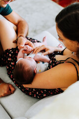 Portrait of a newborn being cared of by his aunt