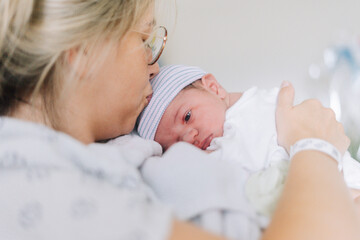 Portrait of a one day old newborn in the hospital with his mom