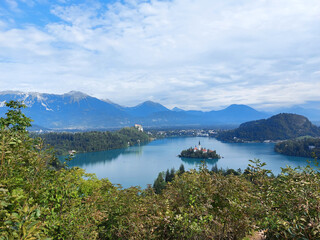 Fototapeta na wymiar lake Bled and dark blue mountains under white clouds. Slovenia.