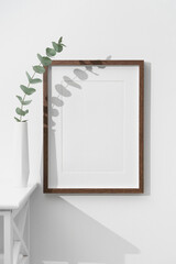 Wooden picture frame mockup on white wall, blank mock up with copy space