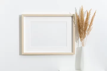 Gordijnen Landscape picture frame mockup in white room interior, blank frame mock up with copy space for art design presentation © nikavera