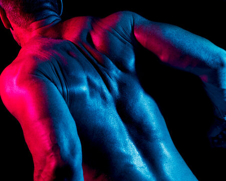 Crop muscular man squeezing shoulder blades together