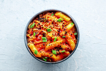 Rabokki, tteokbokki or topokki with ramen, Korean street food, spicy rice cakes in red pepper...