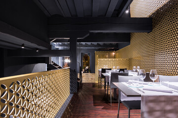 A white table sitting in a room restaurant with gold walls