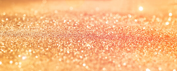 Abstract Defocused Gold Glitter Background with Copy Space.